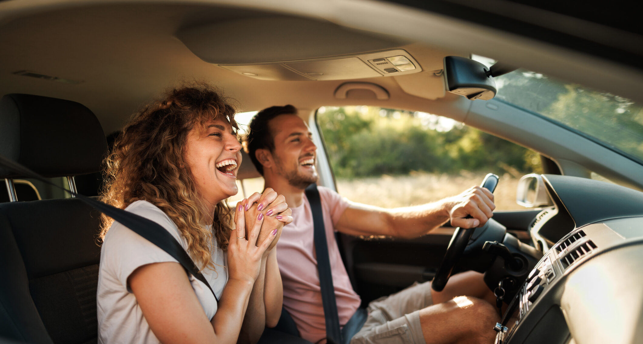 Young couple shares lighthearted moments and laughter during their adventurous car journey